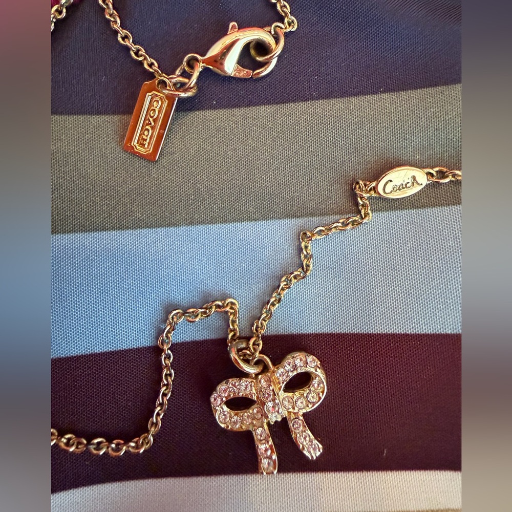 Coach Gold-Tone Crystal Bow Necklace with Legacy Striped Pouch and Coach Logo - Picture 3 of 7